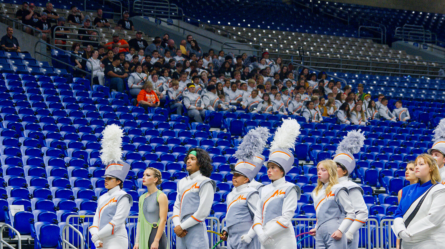 The band's leadership team represents the Sound of the Swarm on the field, as the band members and crew wait in the stands to hear their name announce after prelims and learn what time they will march in the finals.